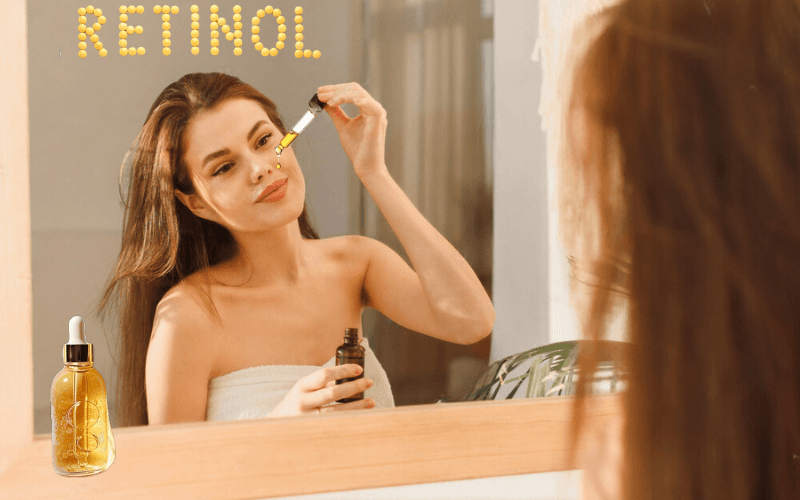 Mulher aplicando sérum de retinol no rosto, representando um momento de autocuidado e atenção às linhas de expressão.